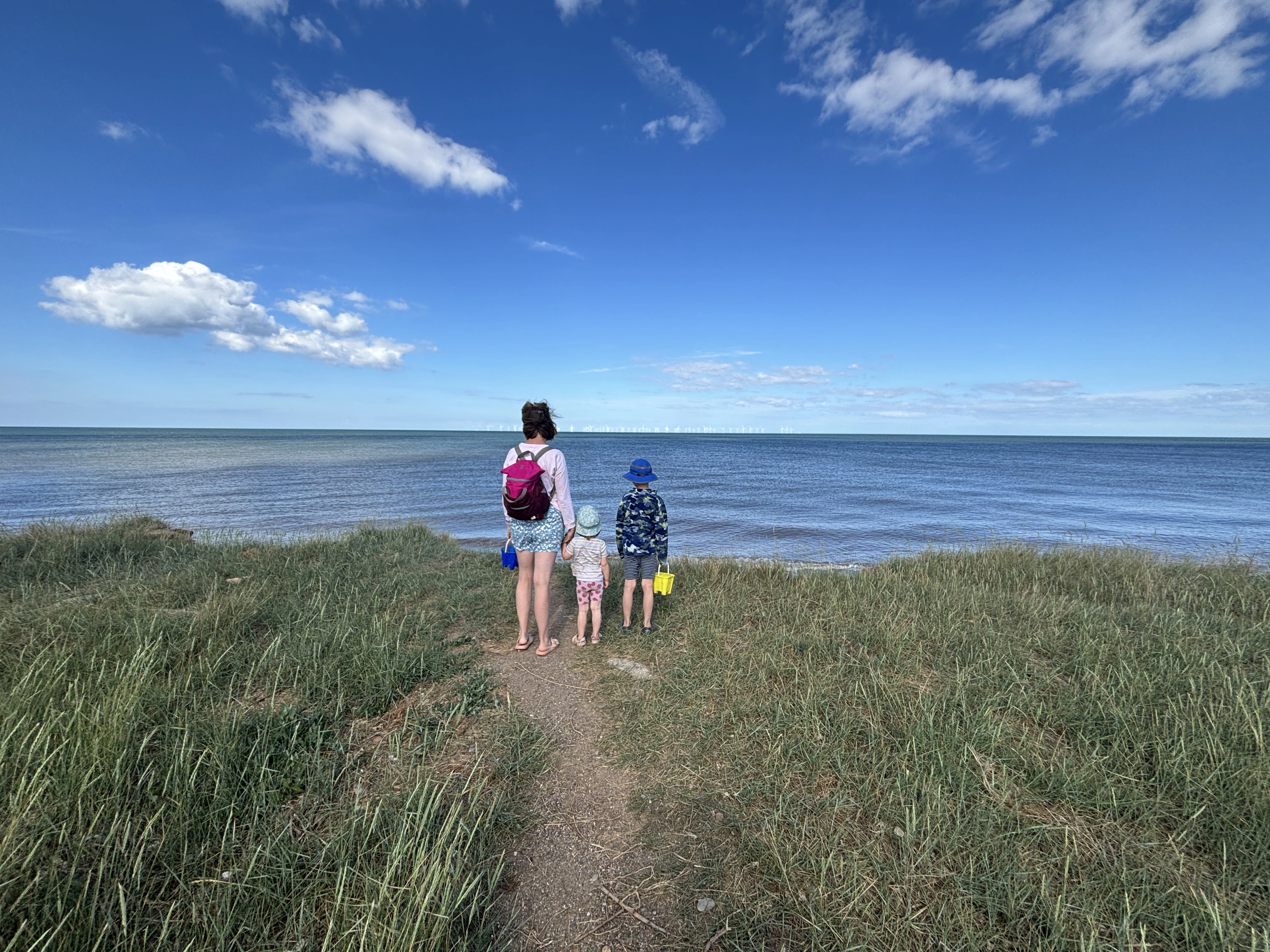 A family on a coastal stop during a private Edinburgh to York scenic transfer